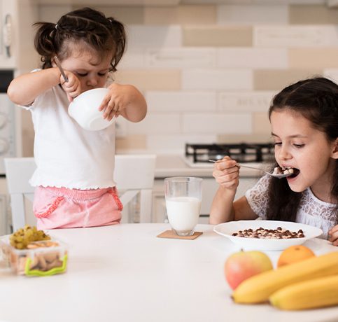 Two Kids Eating Meal