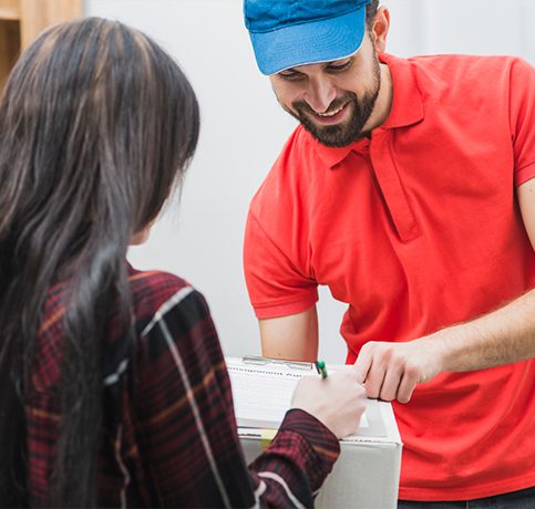 A courier boy in a red T-shirt gives a courier to a girl